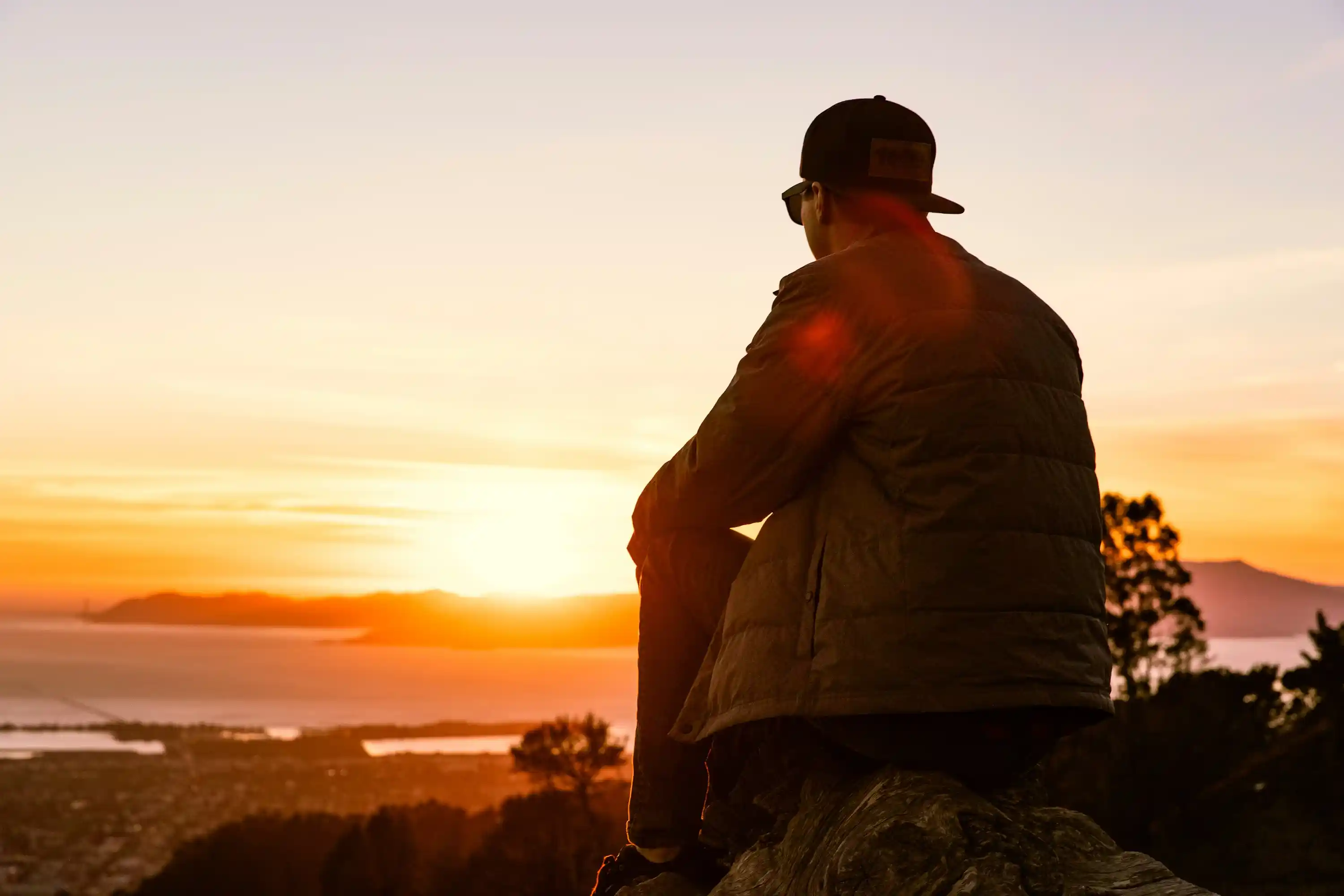 Person enjoying a peaceful morning walk in nature at sunrise